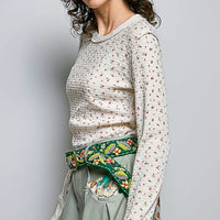 Ivory ribbed knit long sleeve top with tiny floral print and crew neckline