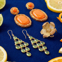 Gold peridot drop earrings with green teardrop stones and a cascading design