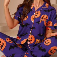 Halloween pajama set in purple with orange pumpkin and bat prints; button-front short-sleeve top