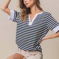 Contrast striped notched knit top, navy and ivory V-neck with short sleeves and side-twist hem.