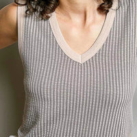 Light grey ribbed V-neck sleeveless tank with contrast trim, neckline close-up.