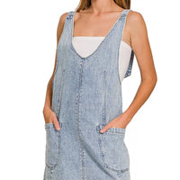 Light wash denim overall dress with adjustable straps and two front pockets