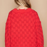 Red checkered sweater with scalloped distressed hem, back view
