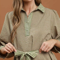 Olive textured mini dress close-up with striped collar placket and tie waist