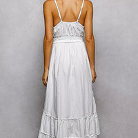 Back view: ivory tiered cami midi dress with spaghetti straps and smocked waist