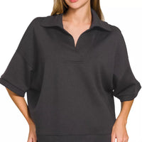 Black collared short-sleeve pullover with half-zip placket