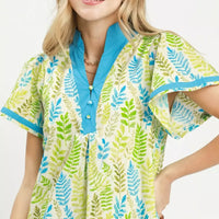 Green and blue leaf print V-neck mini dress with button placket, close-up