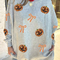 Light gray Halloween sweatshirt with orange pumpkin face and bow sequin motifs