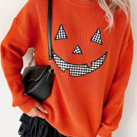 Orange knit sweater with jack-o-lantern graphic, drop-shoulder long sleeves