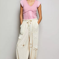 Soft pink V-neck lightweight textured knit top with lace trim and short sleeves