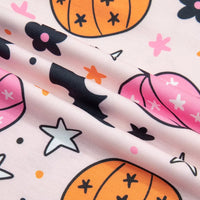 Pumpkin, stars and flower print pajama fabric close-up