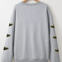 Gray Halloween sweatshirt back view with bat-pattern sleeve accents