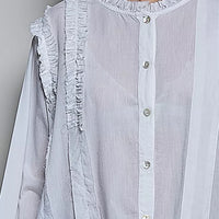 Ivory ruffle-trim round neck woven shirt close-up with button placket