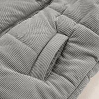 Gray corduroy puffer vest side close-up showing quilted baffles and seam stitching.