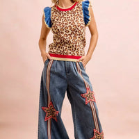 Leopard print sleeveless knit top with blue ruffled sleeves and red neckline trim