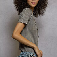 Grey pinstripe short sleeve top with V-neck and stitch seam detail, angled side view
