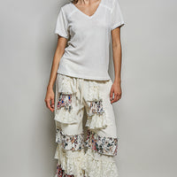 Off-white textured V-neck short-sleeve t-shirt with tiered ruffle skirt, full body