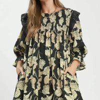 Black-and-cream floral smocked ruffle dress with loose flowy skirt