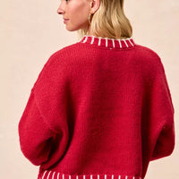 Red knit Christmas sweater, back view with ribbed hem and balloon sleeves.