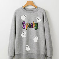 Gray sweatshirt on hanger with sequin 'Spooky' text and white ghost appliques