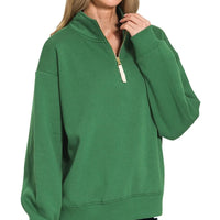 Dark green fleece half-zip pullover with long sleeves and front zip placket