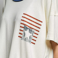 Cream cotton top close-up: blue neckline trim and American flag print with star