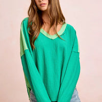 Textured jersey color block top, emerald green with light green sleeves and V-neck