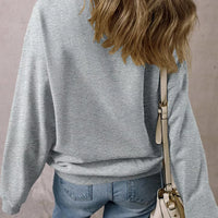 Gray Halloween sweatshirt back view with bat-pattern sleeve accents