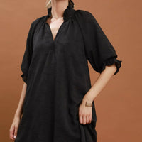 Black V-neck textured dress with gathered shoulders and short puff sleeves