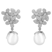 Sparkly crystal flower earrings with silver-toned petals and white pearl drops