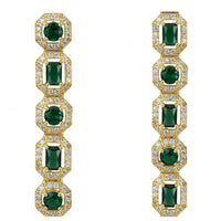Gold drop earrings with emerald-green stones and clear crystal accents