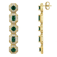 Gold-tone earrings with emerald green stones and visible clasp backs