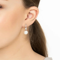 Silver hoop earrings with a pearl drop