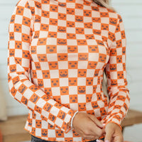 Halloween long sleeve mock neck blouse in orange-and-white checker with jack-o’-lantern faces