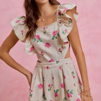 Ivory floral romper with ruffled cap sleeves and cut-out waist, pink rose print