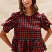 Red plaid peplum top with ribbon bow cuffs and short puff sleeves