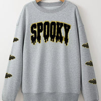 Gray Halloween sweatshirt with sequin 'SPOOKY' front graphic and bat sleeve detail