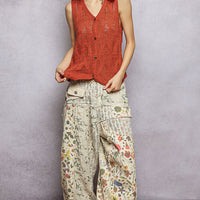 Rust orange knit V-neck button-front sweater vest, sleeveless profile view