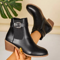 Point-toe block heel boots in black with buckle strap and rounded point toe