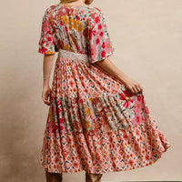 Back view floral print tiered midi dress with flutter sleeves and gathered waist