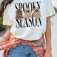 Women's white graphic short-sleeve T-shirt with three spooky season ghost faces