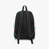 Back view of small kids canvas backpack with black padded straps and colorful doodle print