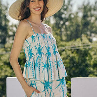 Blue palm tree smocked cami top with adjustable straps and peplum-style ruffles
