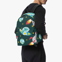 Space-themed canvas backpack on model; dark green with colorful rockets and planet print.