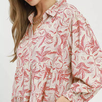 Tiered midi dress with pink botanical print, long sleeves, and gathered ruffle bodice
