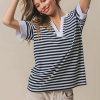 Contrast striped notched knit top, navy and ivory with V-neck and short sleeves.