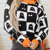 Ghost checkerboard knit sweater in black and white with orange ribbed crew neck