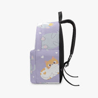 Kids purple kitten-print backpack side view with black webbing straps and hanging cord