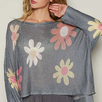 Dark charcoal knit top with long dropped sleeves and floral embroidery-style print