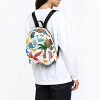 Kids dinosaur backpack worn on back, multicolor dinosaur print with black straps and top handle